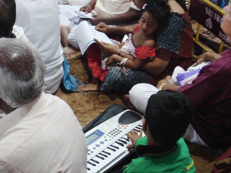 DSC03300.JPG - A boy plays on his Casio as the kritis are sung